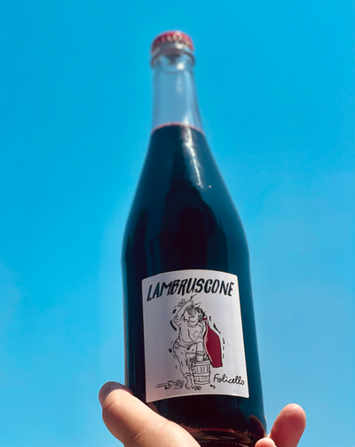 100% Lambrusco  Emilia Romagna.  Woman winemaker - Antonella Fontana. All natural. Chillable red. Pet-Nat (bubbles) Acai bowl with fresh blueberries and blackberries, plums slices and grapefruit zest. salty, funky red fizz extravaganza. Peppered herbs.