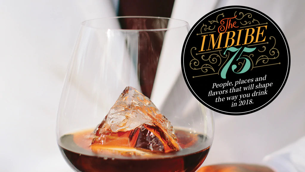 A close up of a dark liquid cocktail with the words: Imbibe 75 (magazine cover)