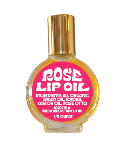 Rose lip oil bottle with gold cap and pink label on a white background