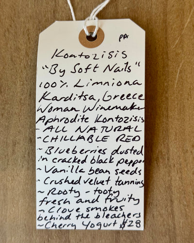 Handwritten tag on a wooden surface with product description