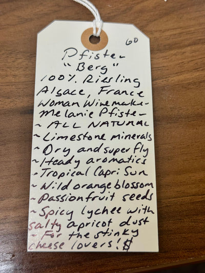 Handwritten wine label on a wooden surface