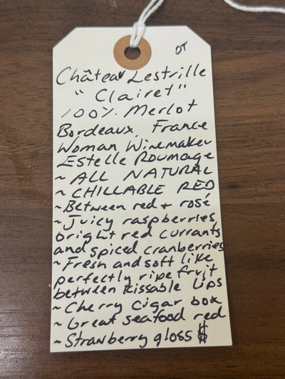 Handwritten wine label on a wooden surface