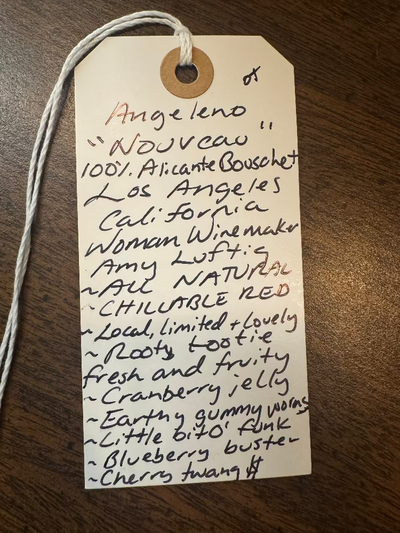 Handwritten wine label on a wooden surface