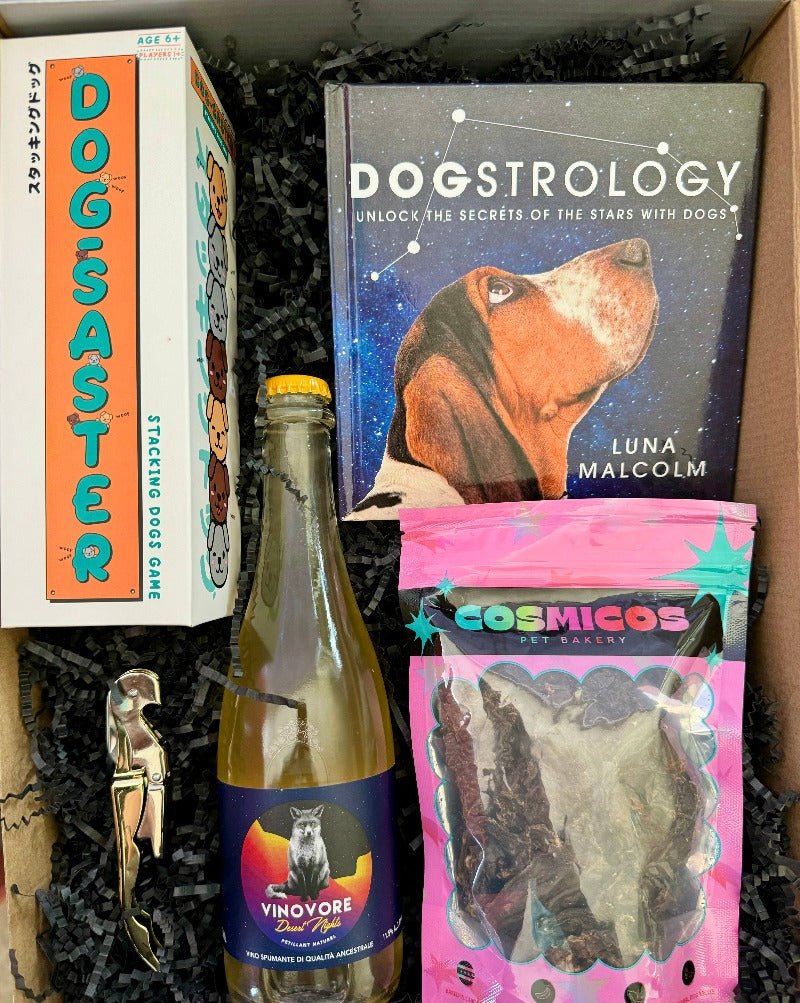 This box includes Vinovore Desert Nights Pēt-Nat half bottle, Dogsaster Stacking Game, Dogstrology book, one pack of Cosmico Dog Treats (must choose flavor) and a corkscrew bottle opener (must choose color).