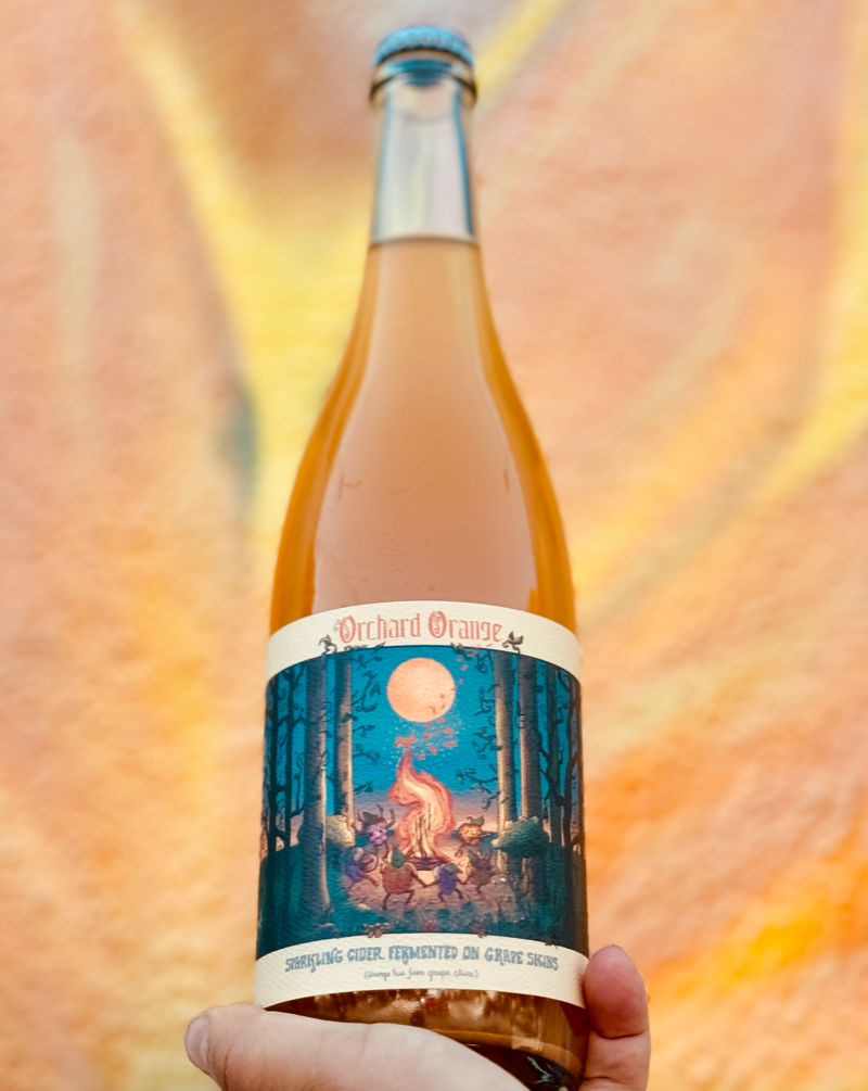 Pinot Grigio Grapes Skins and Gravenstein Apples. Los Angeles, California.  Women winemakers - Chelsea Rosetter. All natural. Orange Wine Pét-Nat (bubbles) Wine and Cider Co-ferment. Low ABV 7% Super DRY and fly. Blood orange zest. Yellow roses. Golden pears. Sunset in a bottle.