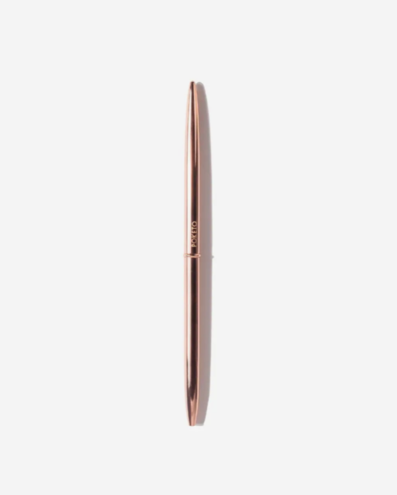 Rose gold pen on a white background