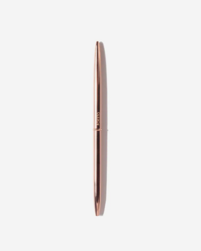Rose gold pen on a white background