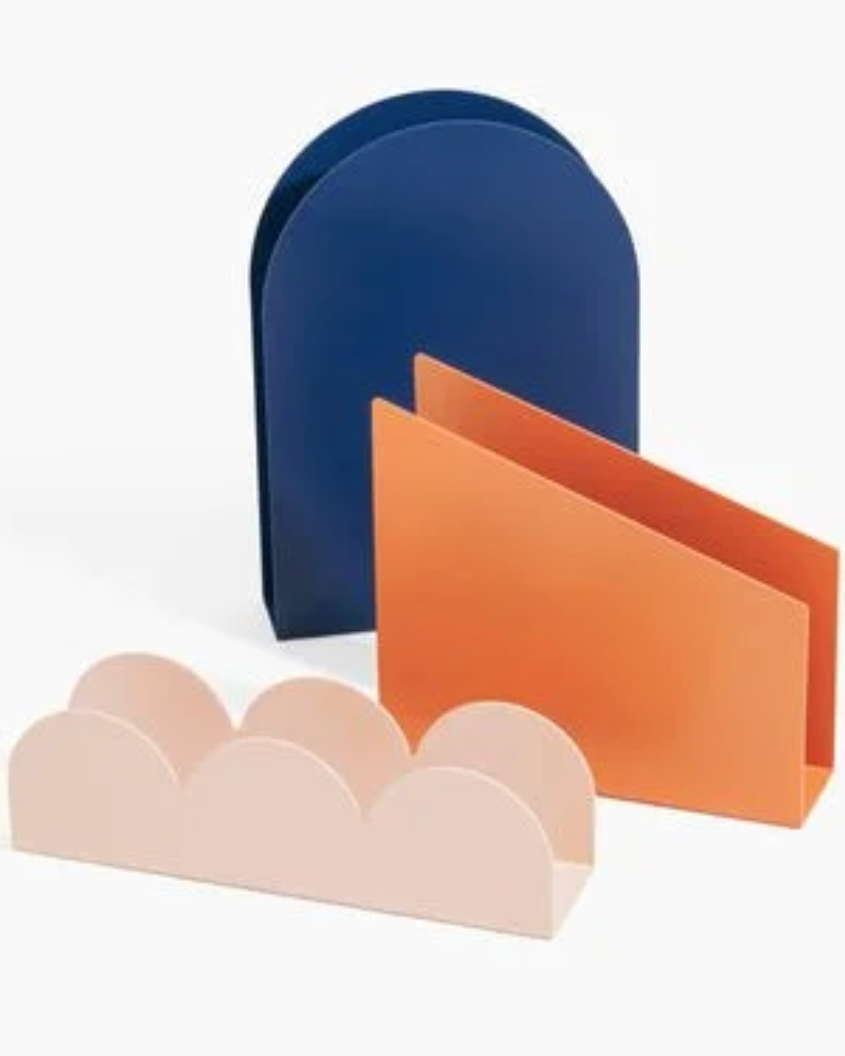 Three colorful metal letter holders on a white background