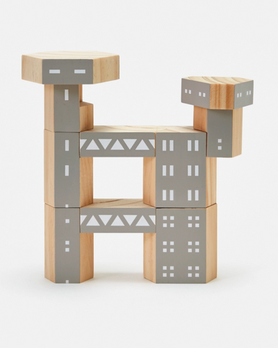 Wooden block toy shaped like a horse with gray and beige design on a white background