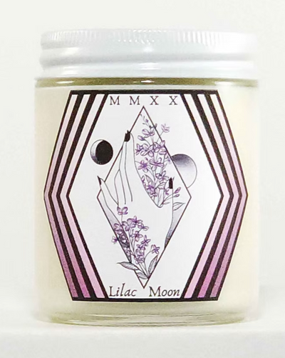 Candle jar with 'Lilac Moon' label featuring geometric design and floral elements on a white background.