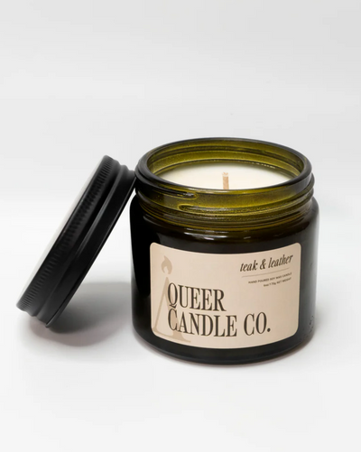 Candle in a jar with 'Queer Candle Co.' label on a white background