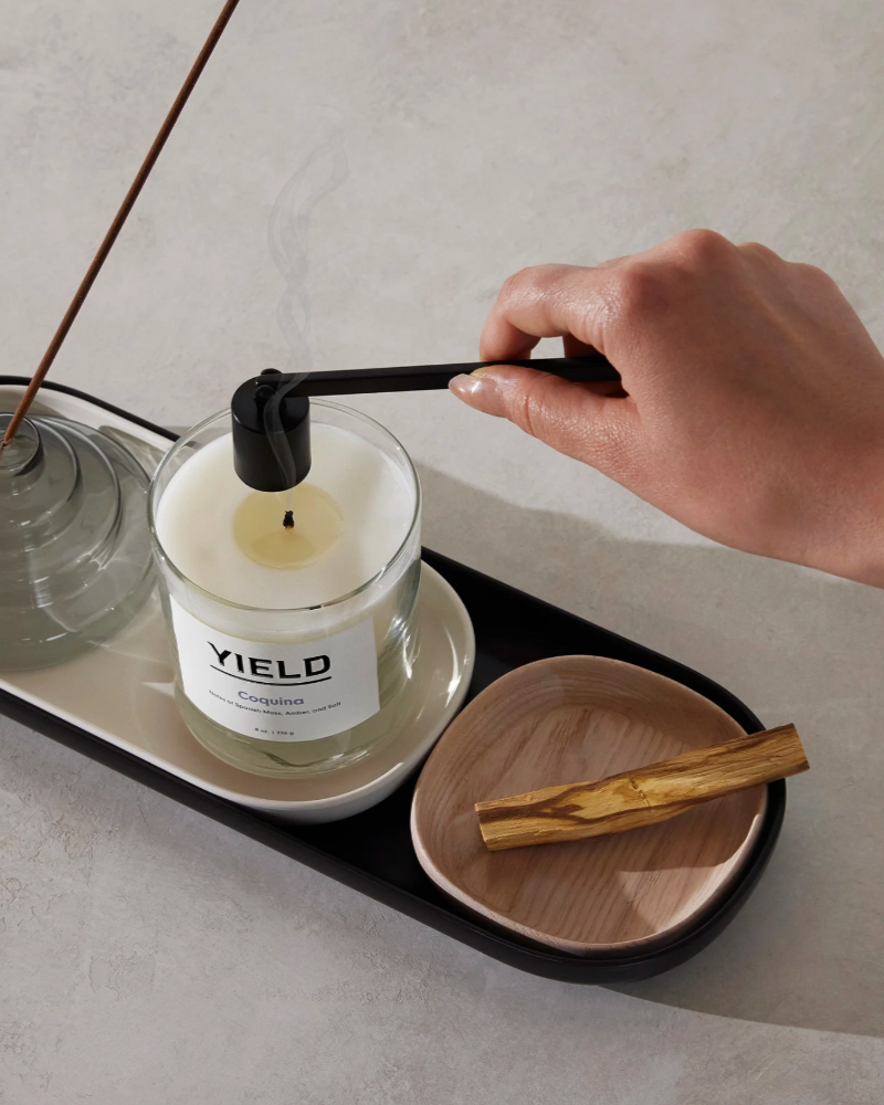 Hand snuffing a Yield candle 
