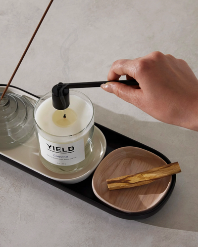 Hand snuffing a Yield candle 