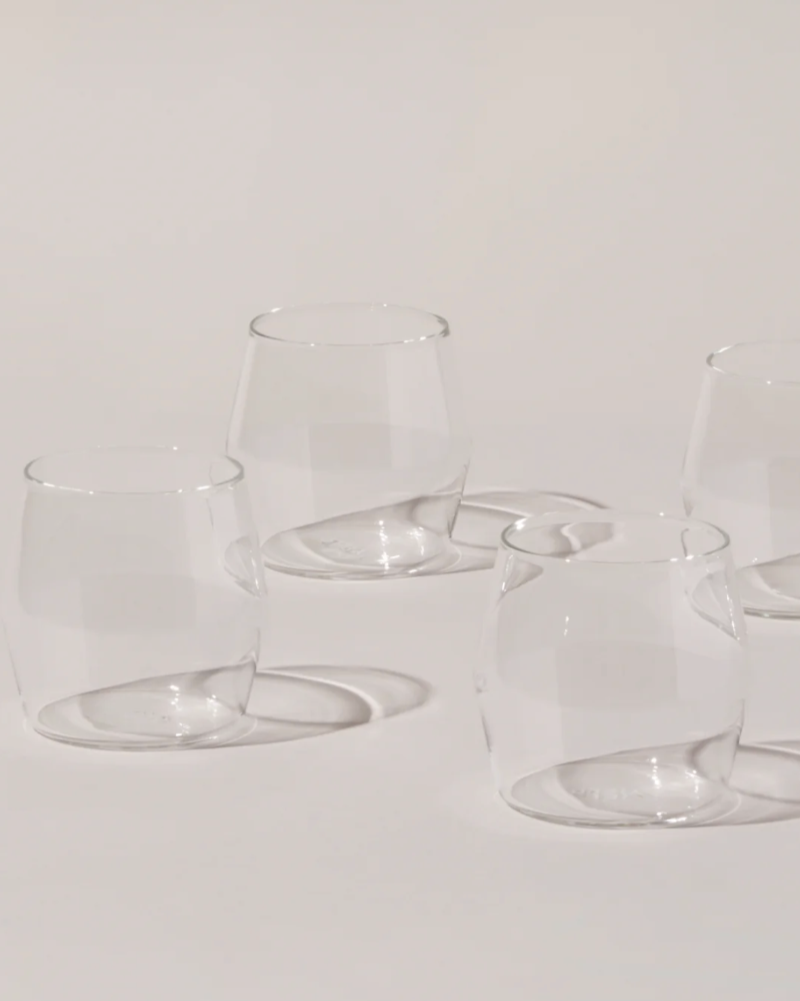 Set of clear glass tumblers on a light gray background