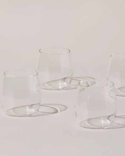 Set of clear glass tumblers on a light gray background