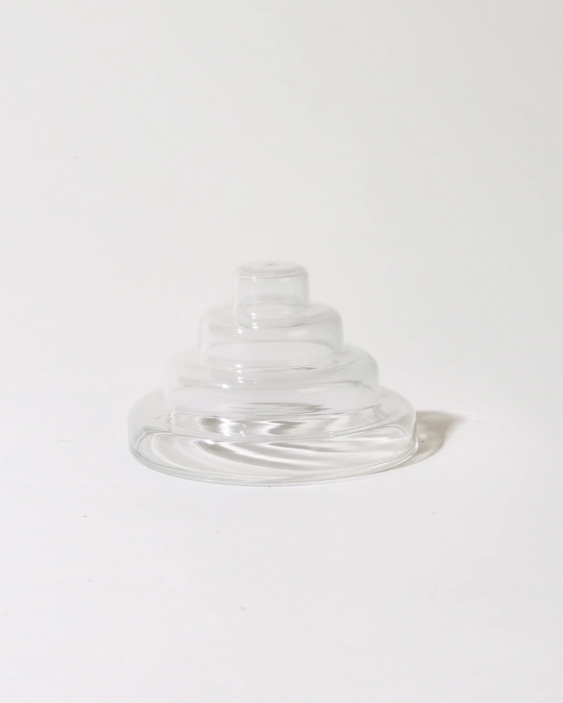 Clear glass incense holder on a white background