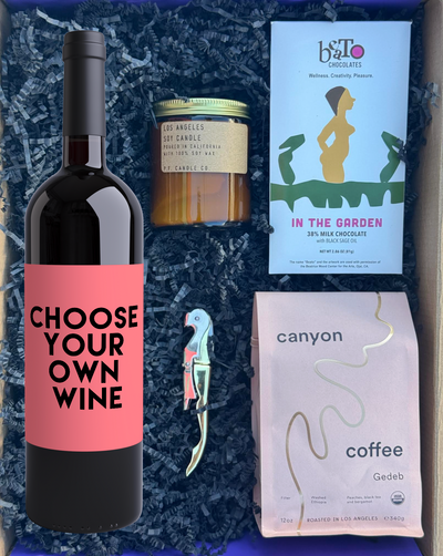 Wine bottle with pink label, chocolate bar, and coffee package in a box.