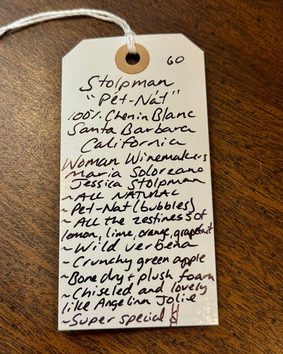 Handwritten wine label on a wooden surface