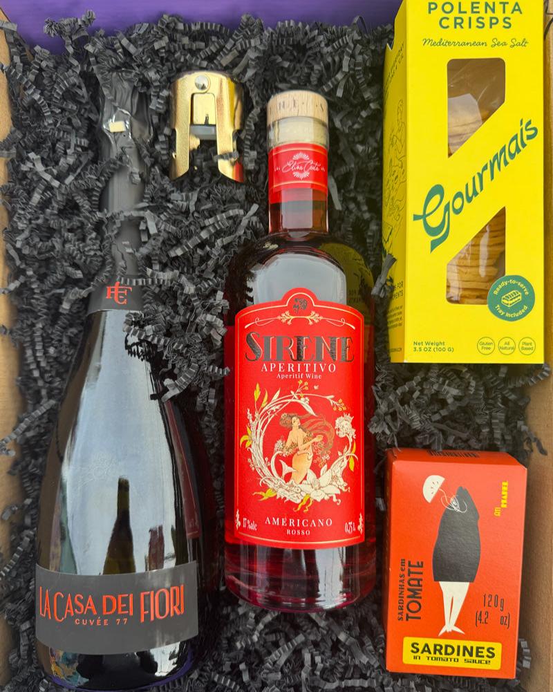 Our Aperitivo Spritz &amp; Snack Kit Box includes:

Clara C La Casa dei Fiori Prosecco, Liquore della Sirene Americano Rosso Aperitivo, Gourmais Polenta Crisps, Ati Manel Sardines in Tomato Sauce, bottle stopper.