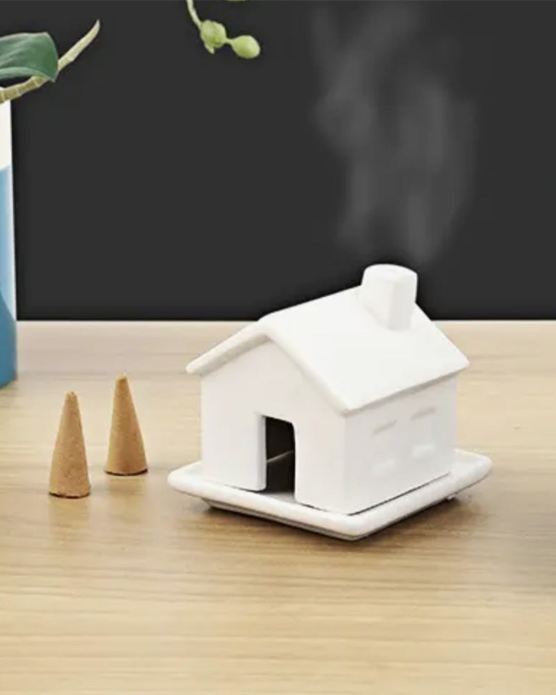 Make your house a home with this tiny incense house. Fills your room with its sandalwood scent as your watch puffs of smoke leave its chimney. Includes 1 incense house, 1 resting dish, and 3 incense cones in sandalwood scent.Designed in London by Gift Republic