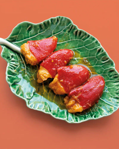 Savor the exquisite flavors of our White Tuna Stuffed Piquillo Peppers. Roasted to perfection and generously filled with premium Bonito del Norte White Tuna, they bathe in a creamy tomato sauce—a true taste of Spanish culinary heritage in every bite. Serving them is a breeze—enjoy straight from the tin for an explosion of flavor, or gently heat them in a pan to savor every drop of the luscious sauce. With four peppers per tin, they're perfect for sharing or indulging solo.