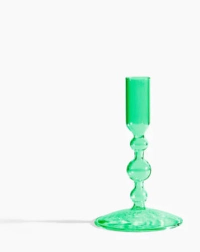 Whether it's catching the sunlight during the day or the flickering of warm candlelight over dinner at night, this shapely glass candlestick holder will definitely bring new dimensions to your table.