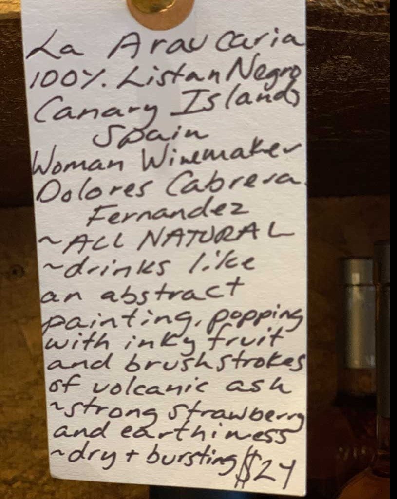 100% Listan Negro Canary Islands, Spain.  Woman winemaker - Dolores Cabrera Fernandez. All natural. Drinks like an abstract painting, popping with inky fruit and brushstrokes of volcanic ash. Strong strawberry and earthiness. Dry + bursting.