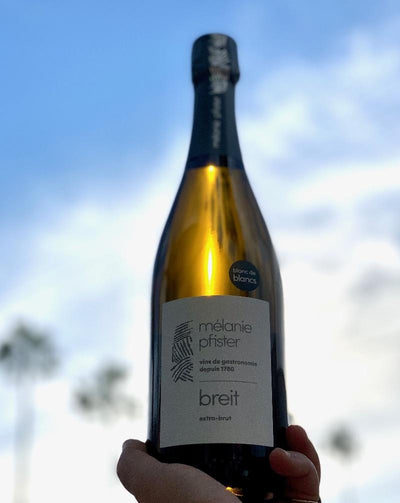 50% Chardonnay. 50% Pinot Blanc. Alsace, France.  Woman winemaker - Mélanie Pfister. All natural. Blanc de blanc. So dry and tasty. Brioche loaves. Drinks like Champagne. Green apple butter. Fresh pine. Tiny bubbles.