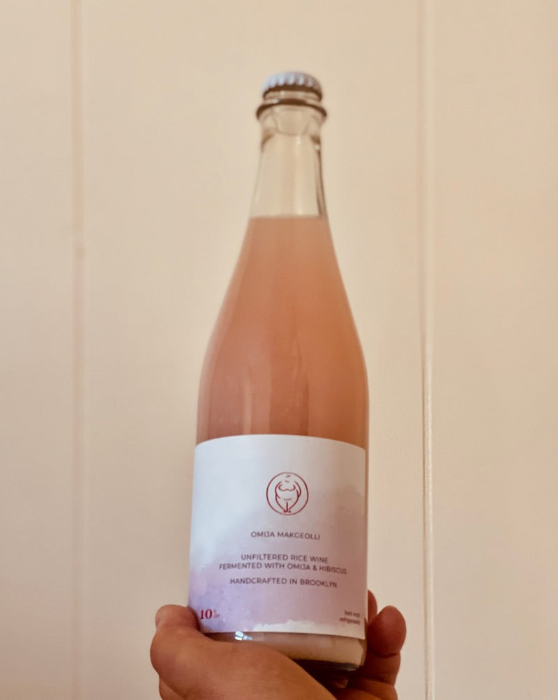 Female Winemaker (Brewer) - Alice  OMIJA MAKGEOLLI | Naturally fermented, unfiltered rice wine made using traditional Korean brewing methodologies. Light in body, dry, with the subtle salty, tangy, and bitter profile of omija berries and hibiscus flowers.  Best kept refrigerated or stored in a cool, dry place away from direct sunlight. Shake gently to incorporate sediment and enjoy cold.