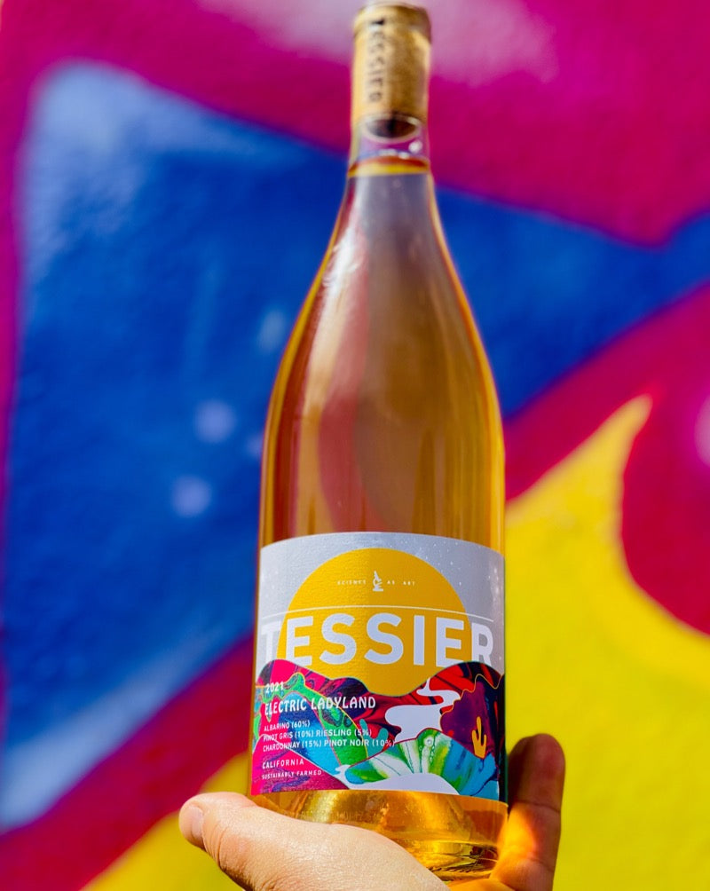 65% Albarino, 15% Chardonnay, 10% Pinot Gris, 10% Pinot Noir 5% Riesling. El Dorado, California.  Woman winemaker - Kristie Tracey. All Natural. Orange wine 5 grape blended tribute to Jimi Hendrix. A psychedelic wine trip through a magical land of fleshy peaches, perky pineapples wild orange peels in bran cereal. 