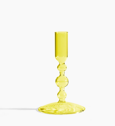 Whether it's catching the sunlight during the day or the flickering of warm candlelight over dinner at night, this shapely glass candlestick holder will definitely bring new dimensions to your table.