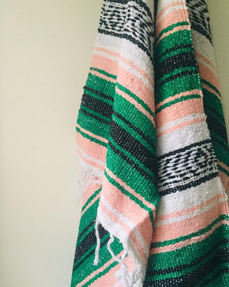 Measure 74" x 48" Colors: Peach, Green, Black & White Fringe detail on two ends Soft blend of cotton, acrylic and polyester Washes well in cold cycle and recommended to air dry Perfect as your favorite couch or bed throw, picnics, concerts, and the beach